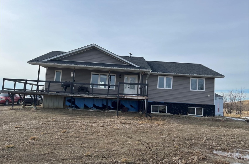 Front view of property featuring a wooden covered deck