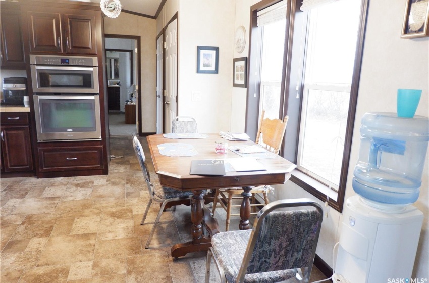 Tiled dining space featuring crown molding