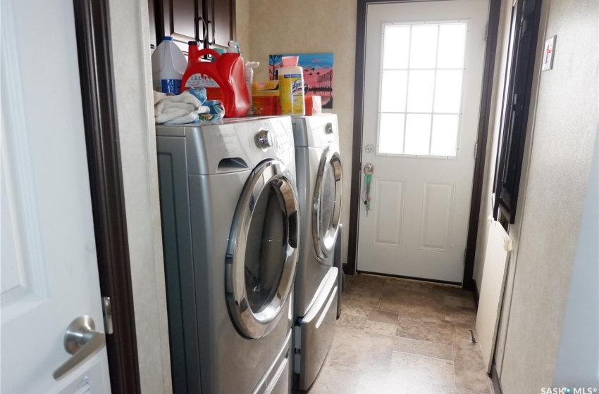 Laundry room with washer and dryer and light tile floors