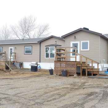 View of front of property featuring a wooden deck