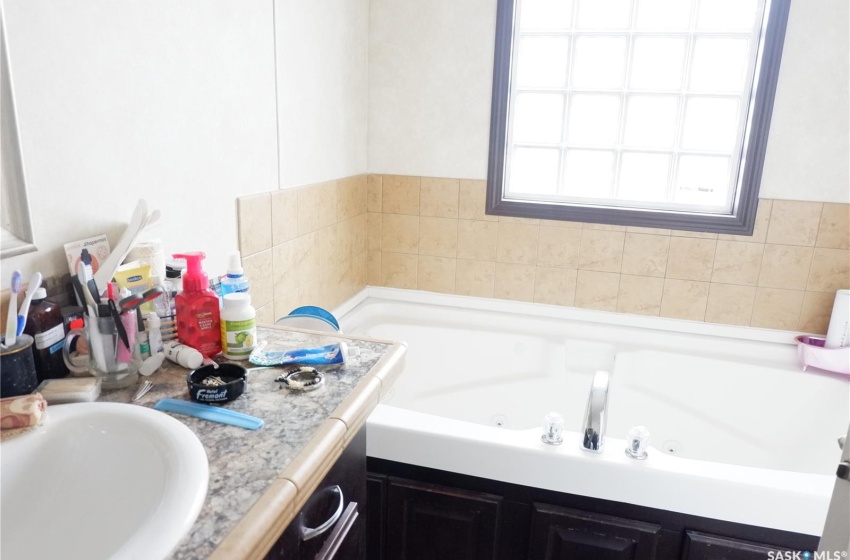 Ensuite Bathroom featuring a washtub and vanity