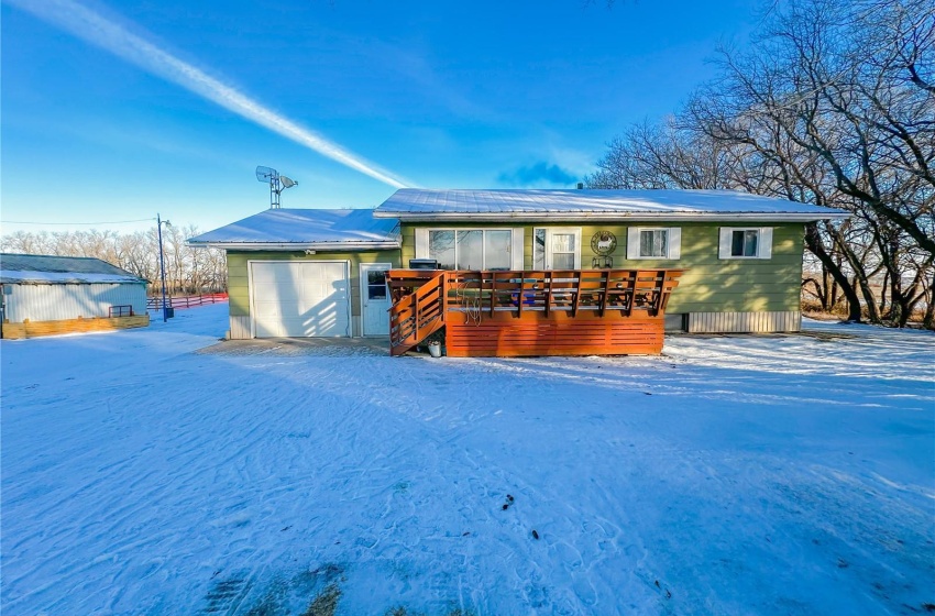 View of front of house with a garage and a wooden deck