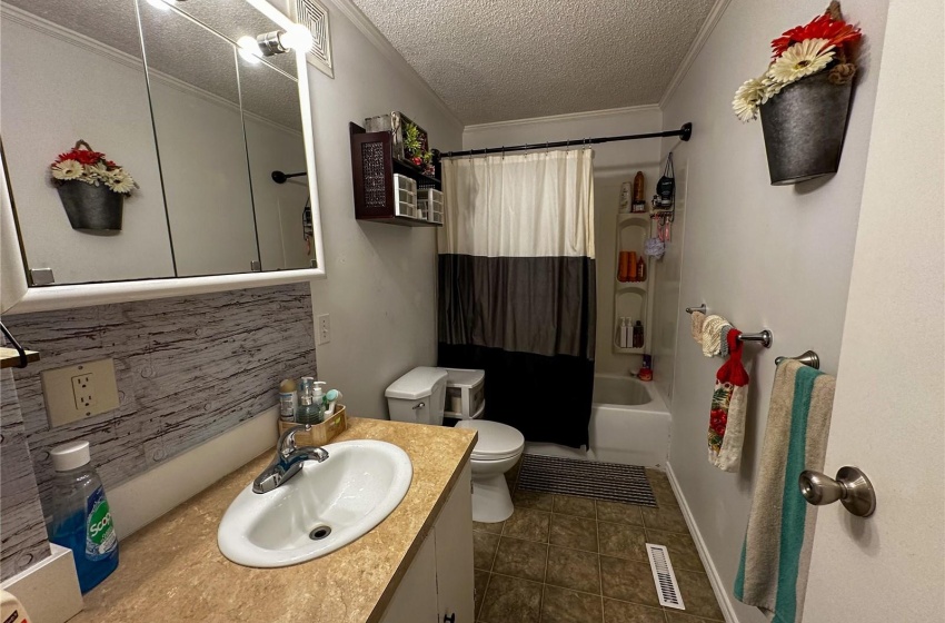 Full bathroom with toilet, a shower / bath combo, and large vanity