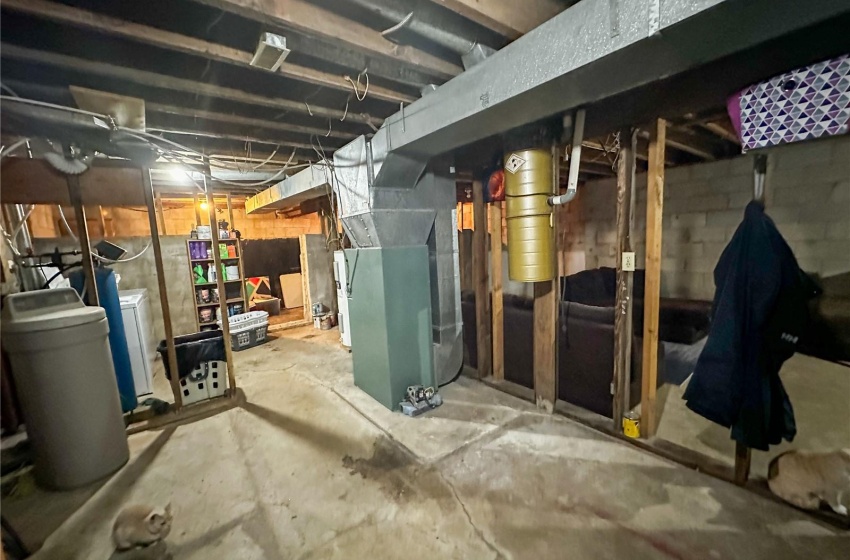 Basement featuring washer and dryer and heating utilities