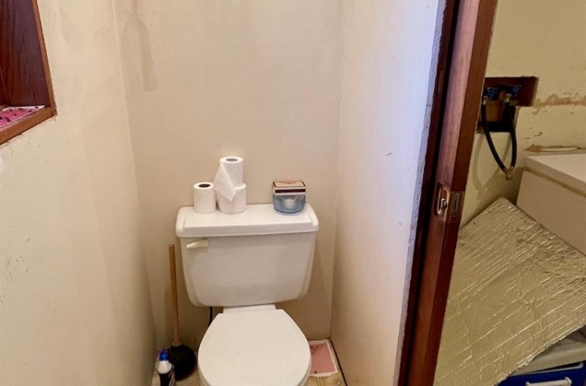 Bathroom featuring toilet and linoleum flooring