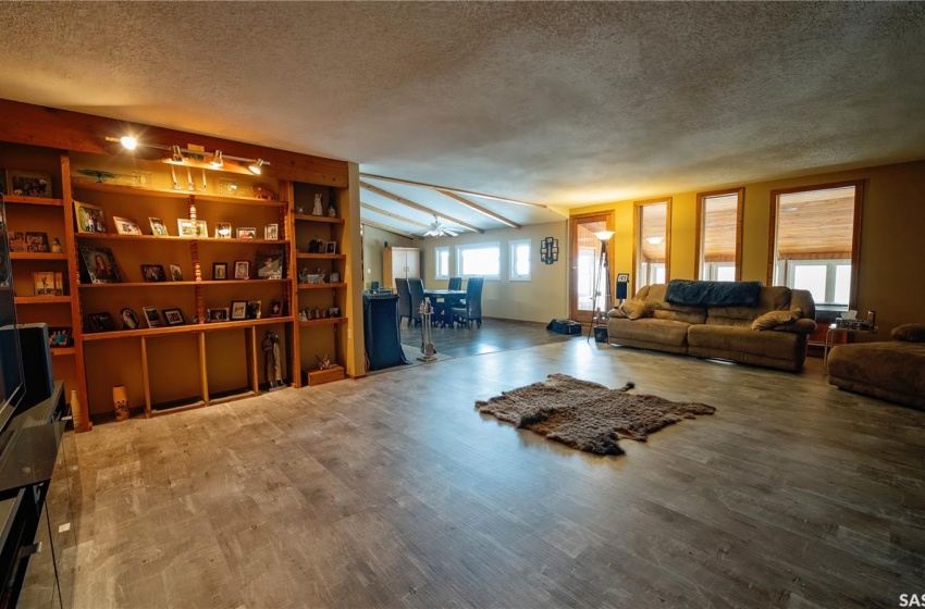 Living room featuring dark hardwood / wood-style flooring, a healthy amount of sunlight, and a textured ceiling