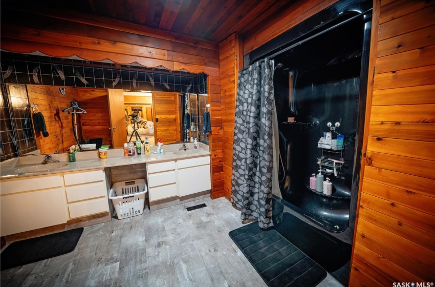 Bathroom featuring vanity, wood ceiling, hardwood / wood-style floors, and wood walls