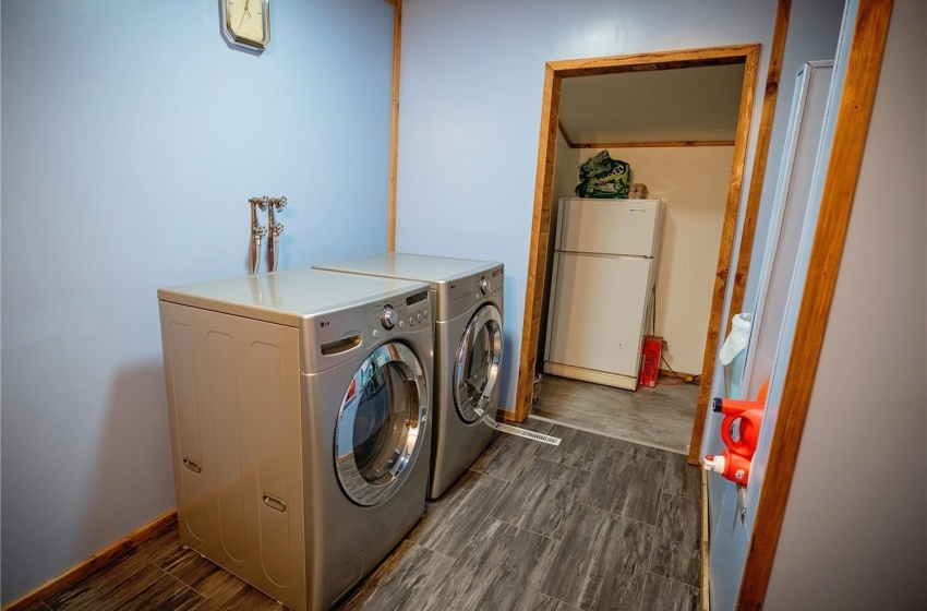 Laundry area featuring washing machine and clothes dryer, dark hardwood / wood-style floors, and washer hookup