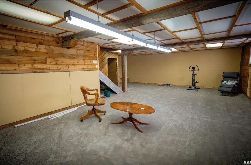 Unfurnished room featuring wooden walls and concrete floors