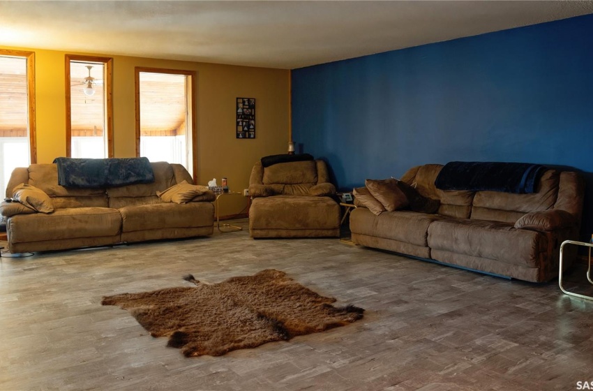 Living room with dark wood-type flooring