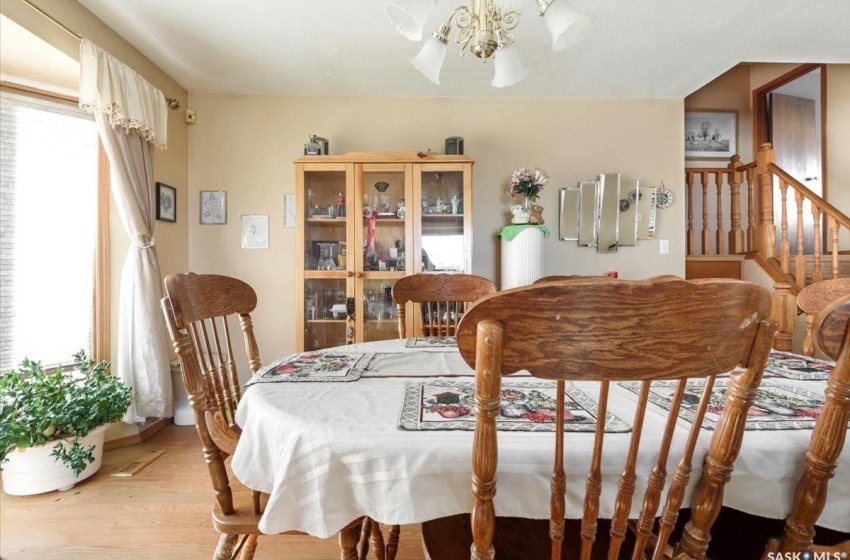 Dining area featuring a wealth of natural light, light wood-type flooring, and an inviting chandelier