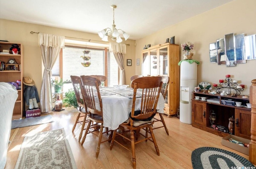 Dining area with a chandelier and light wood-type flooring