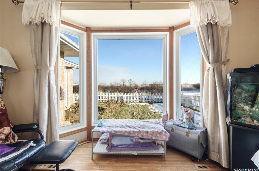 Sitting room with a healthy amount of sunlight and light wood-type flooring