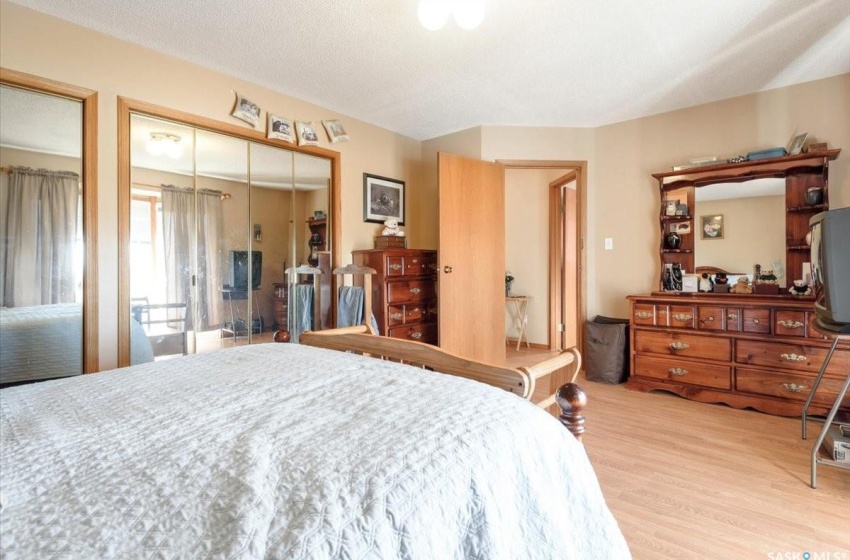 Bedroom with light wood-type flooring and a closet