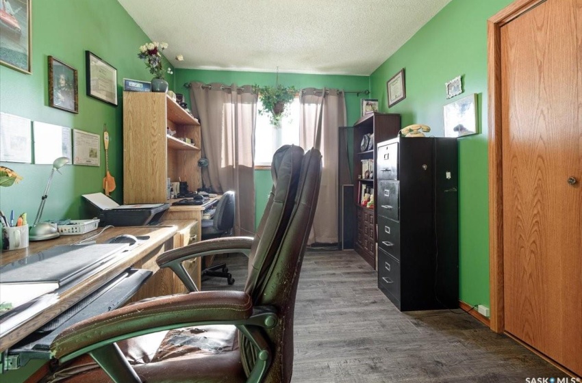 Office with a textured ceiling and hardwood / wood-style floors