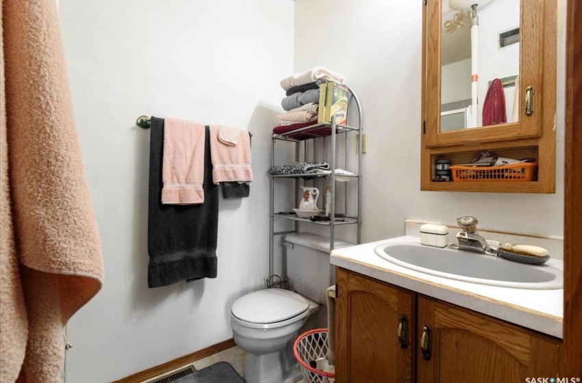 Bathroom featuring vanity, toilet, and tile flooring