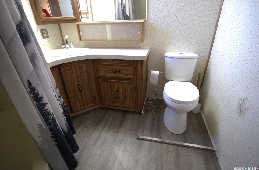 Bathroom featuring hardwood / wood-style floors, oversized vanity, and toilet