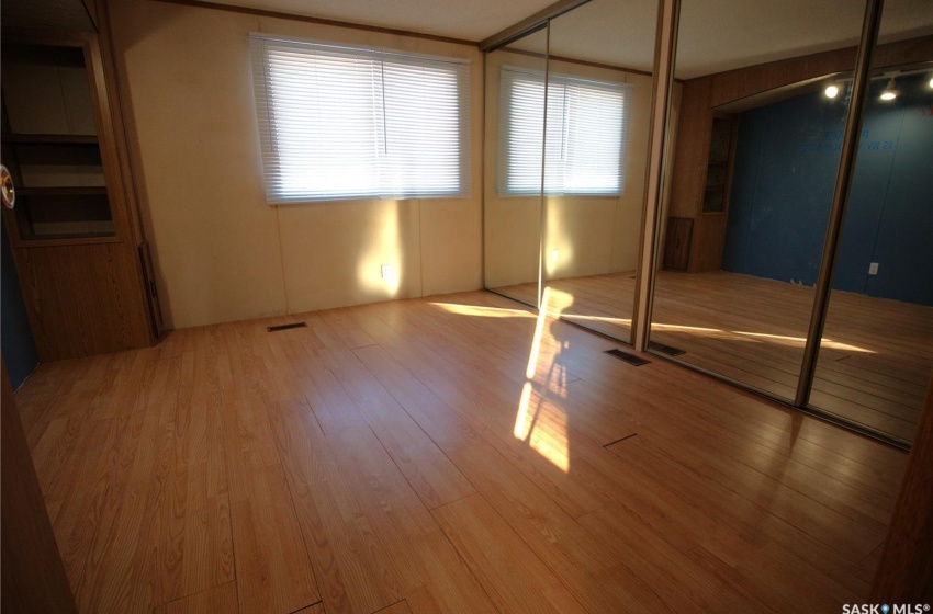 Unfurnished bedroom with light hardwood / wood-style floors and a closet