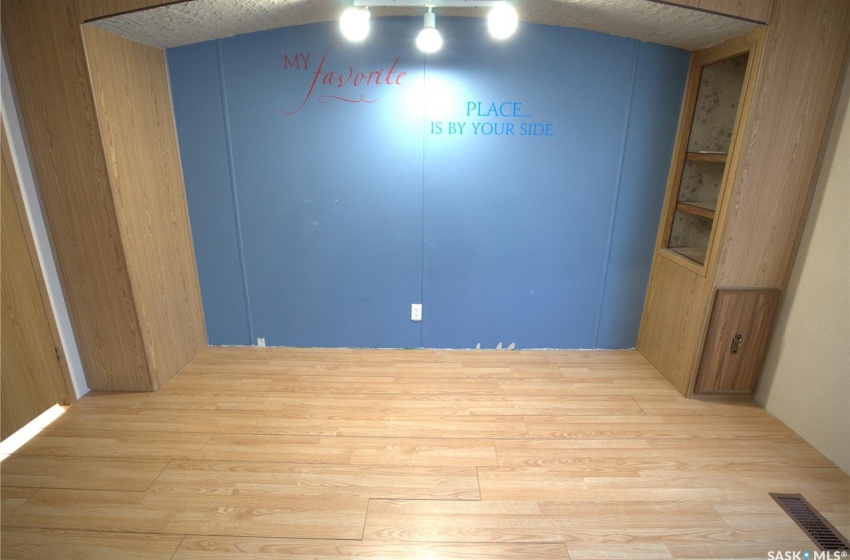 Spare room featuring light hardwood / wood-style floors and wood walls