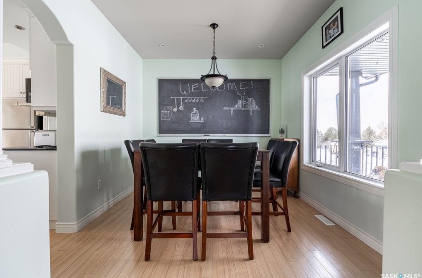 Dining space featuring light wood-type flooring and a healthy amount of sunlight