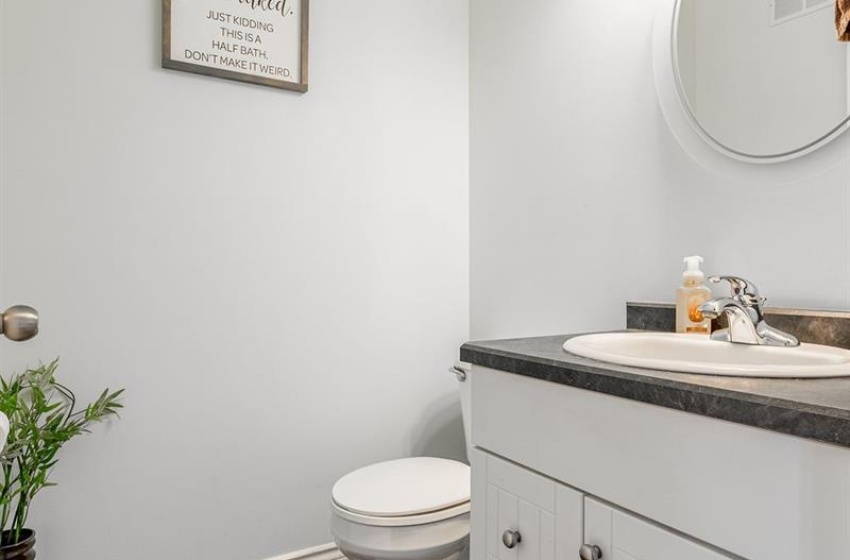 Bathroom featuring tile floors, vanity, and toilet