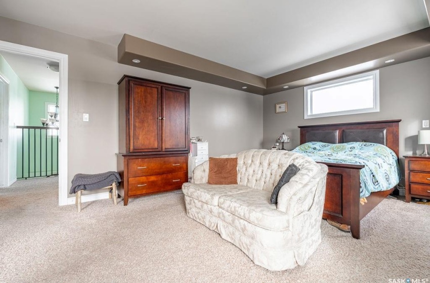 Bedroom featuring light carpet