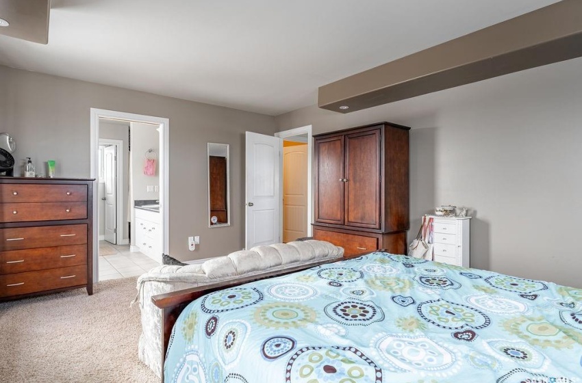 Carpeted bedroom featuring connected bathroom