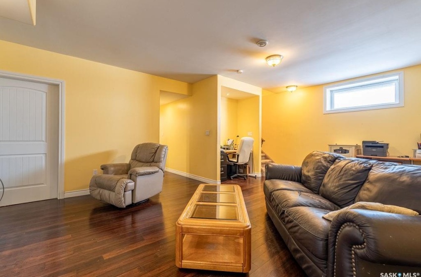 Living room with dark wood-type flooring