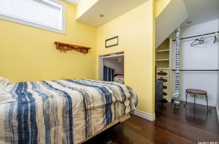 Bedroom with dark hardwood / wood-style flooring