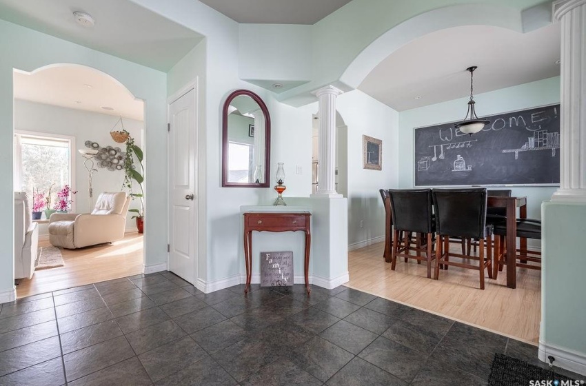 Dining area with dark hardwood / wood-style floors and ornate columns