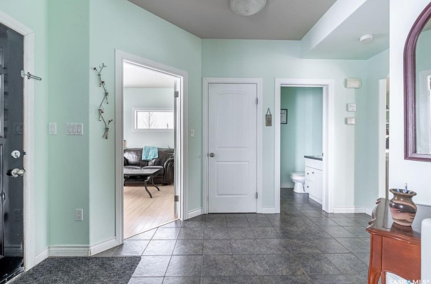 Hallway featuring dark tile flooring