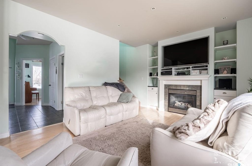 Tiled living room featuring built in features