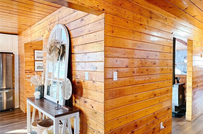 Corridor with wood ceiling, light hardwood / wood-style floors, and wood walls