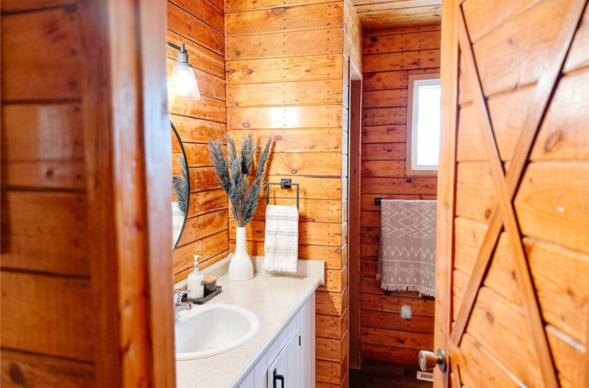 Bathroom featuring vanity, hardwood / wood-style floors, and wood walls