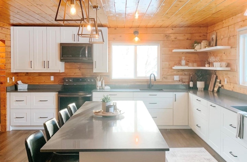 Kitchen with a kitchen bar and wood walls