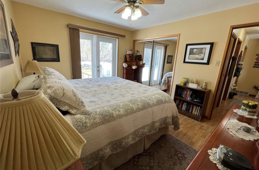 Master bedroom, featuring doors to back deck and hot tub