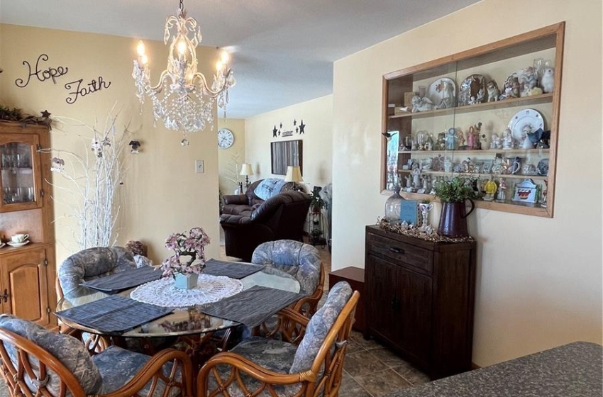 View of dining room from kitchen, featuring built-in display cabinet