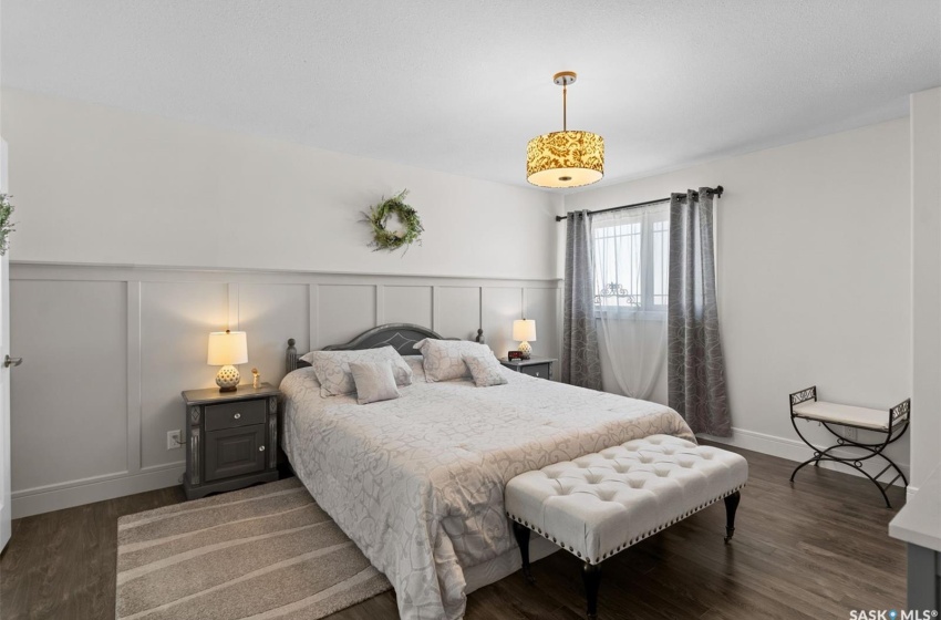 Bedroom with dark hardwood / wood-style floors