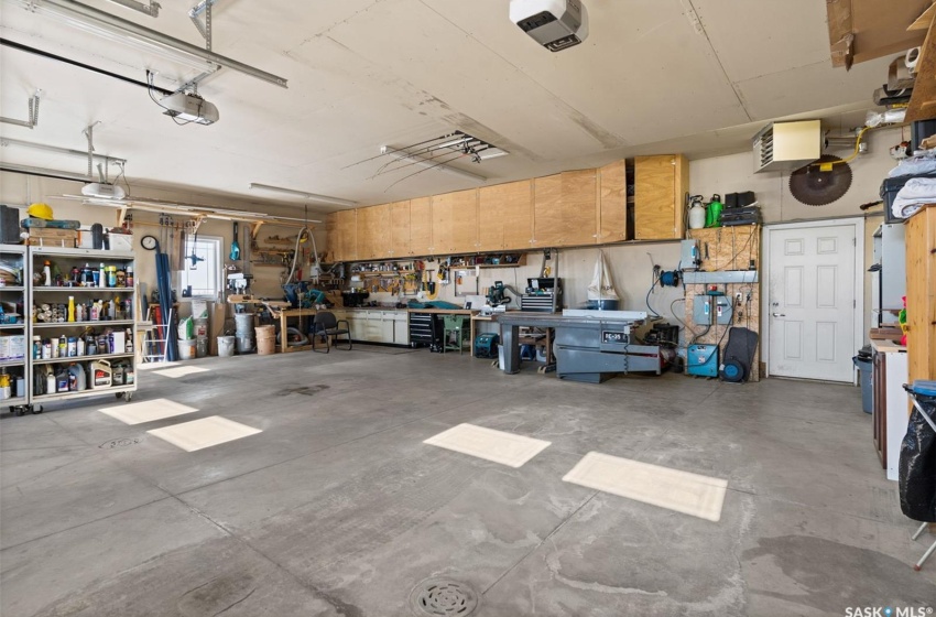 Garage featuring a garage door opener and a workshop area