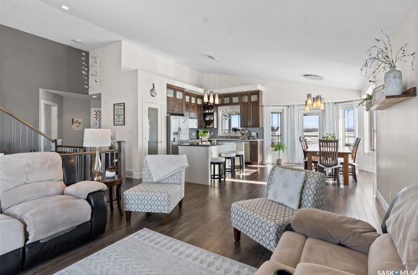 Living room featuring a chandelier, dark hardwood / wood-style floors, and high vaulted ceiling