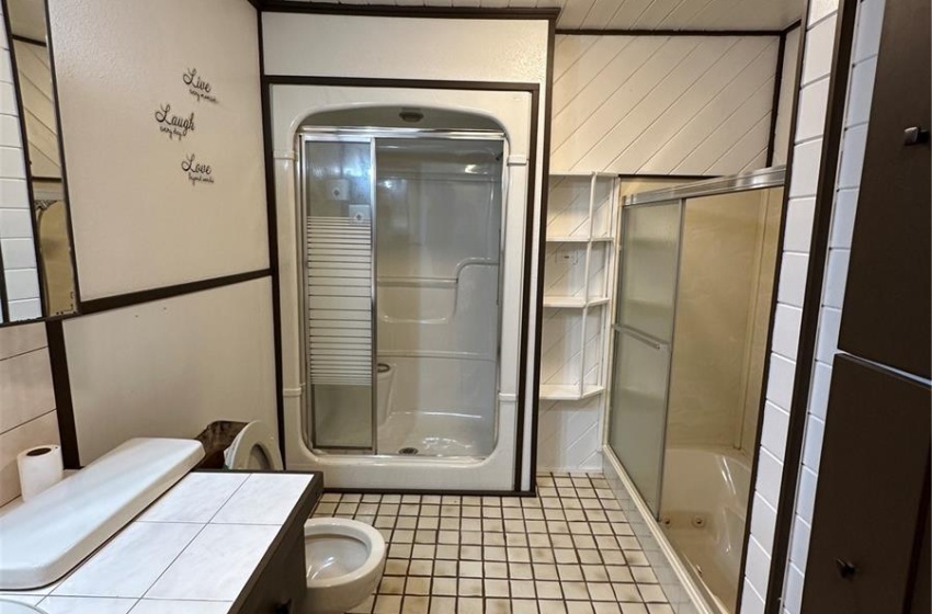 Bathroom with tile floors, vanity, ornamental molding, and toilet