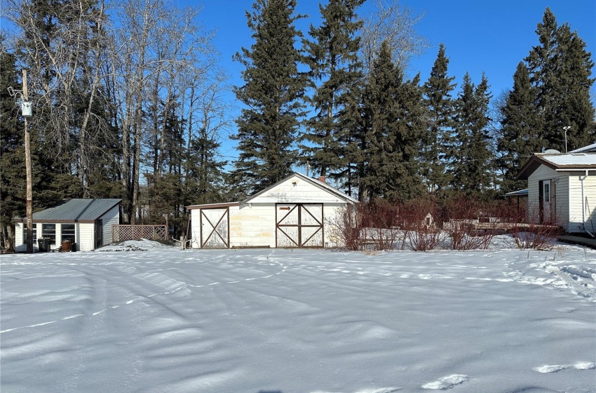 Yard covered in snow featuring an outdoor structure