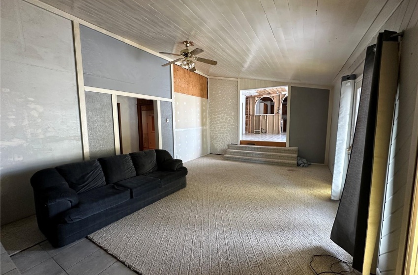 Living room featuring wood ceiling and ceiling fan