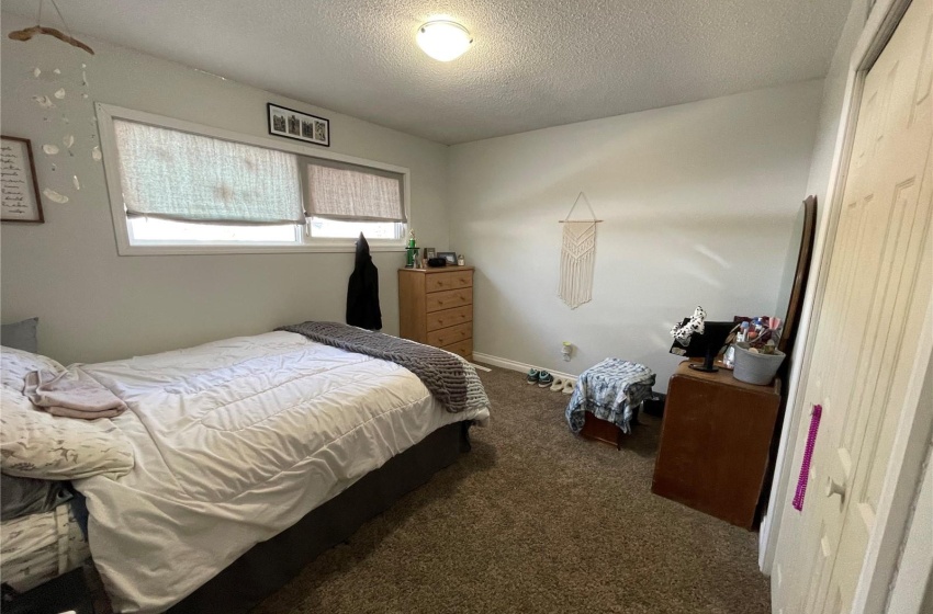 Carpeted bedroom with a textured ceiling