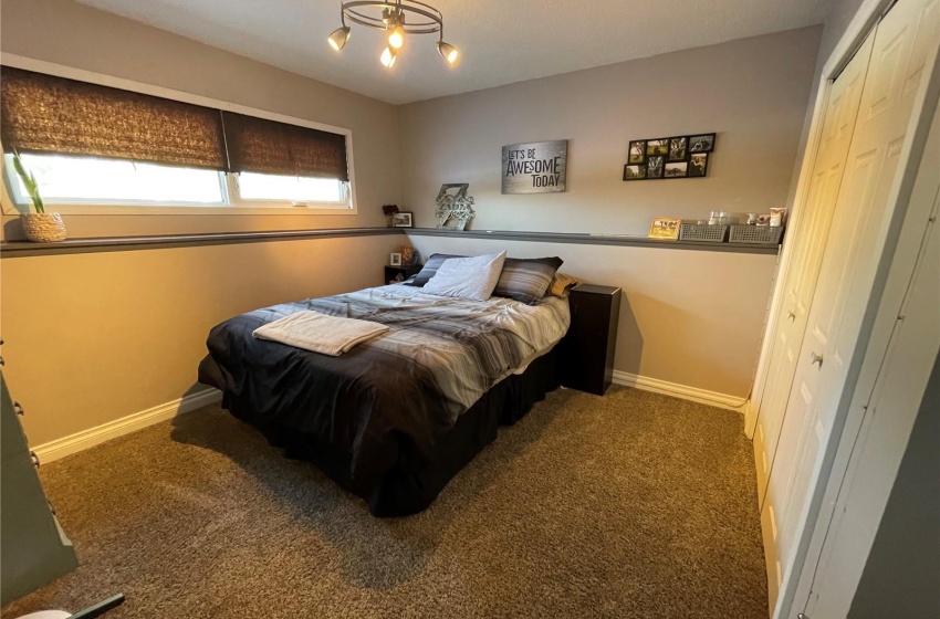 Carpeted bedroom with a notable chandelier