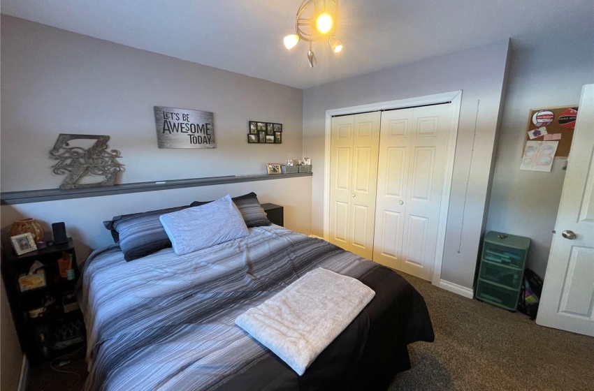 Bedroom featuring dark carpet and a closet