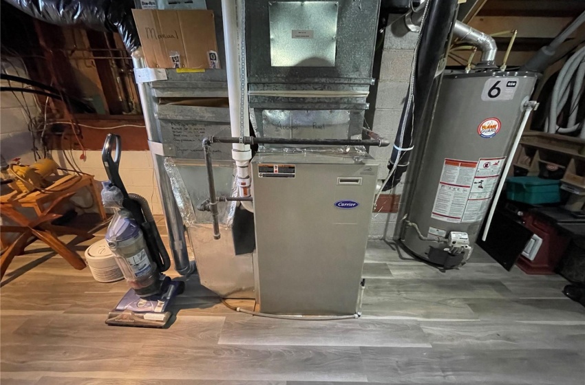 Utility room featuring water heater and heating utilities