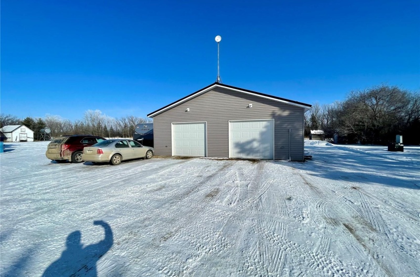 View of snowy exterior featuring a garage