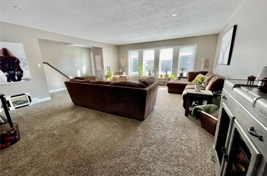 Carpeted living room with a textured ceiling