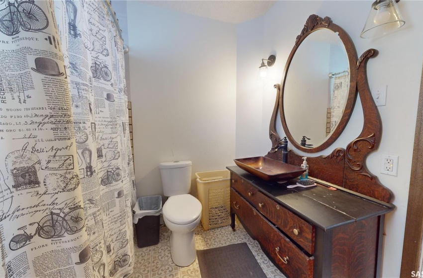 Bathroom with vanity, toilet, and tile flooring